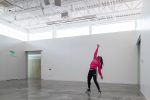 Interior photo of a woman dancing inside of a bare studio in the ArtLab