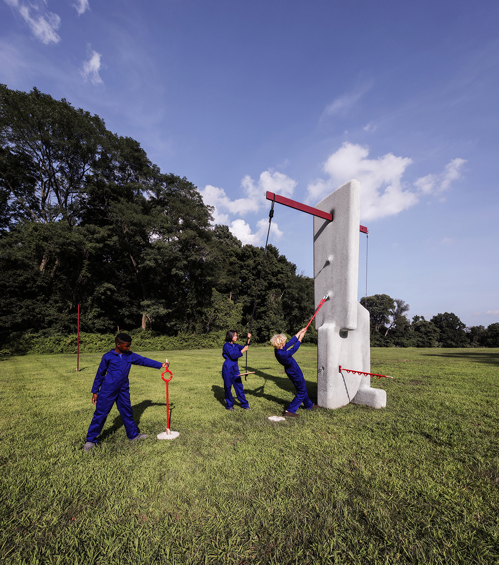 Children playing with a concrete obelisk and red beams