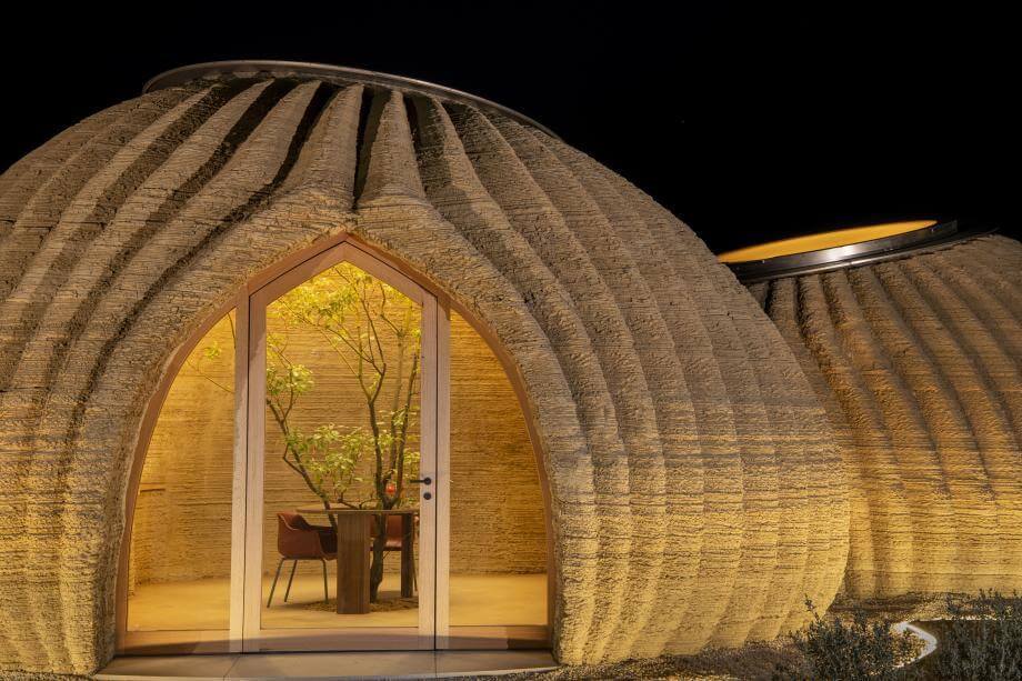 circular-twin clay home pictured at night