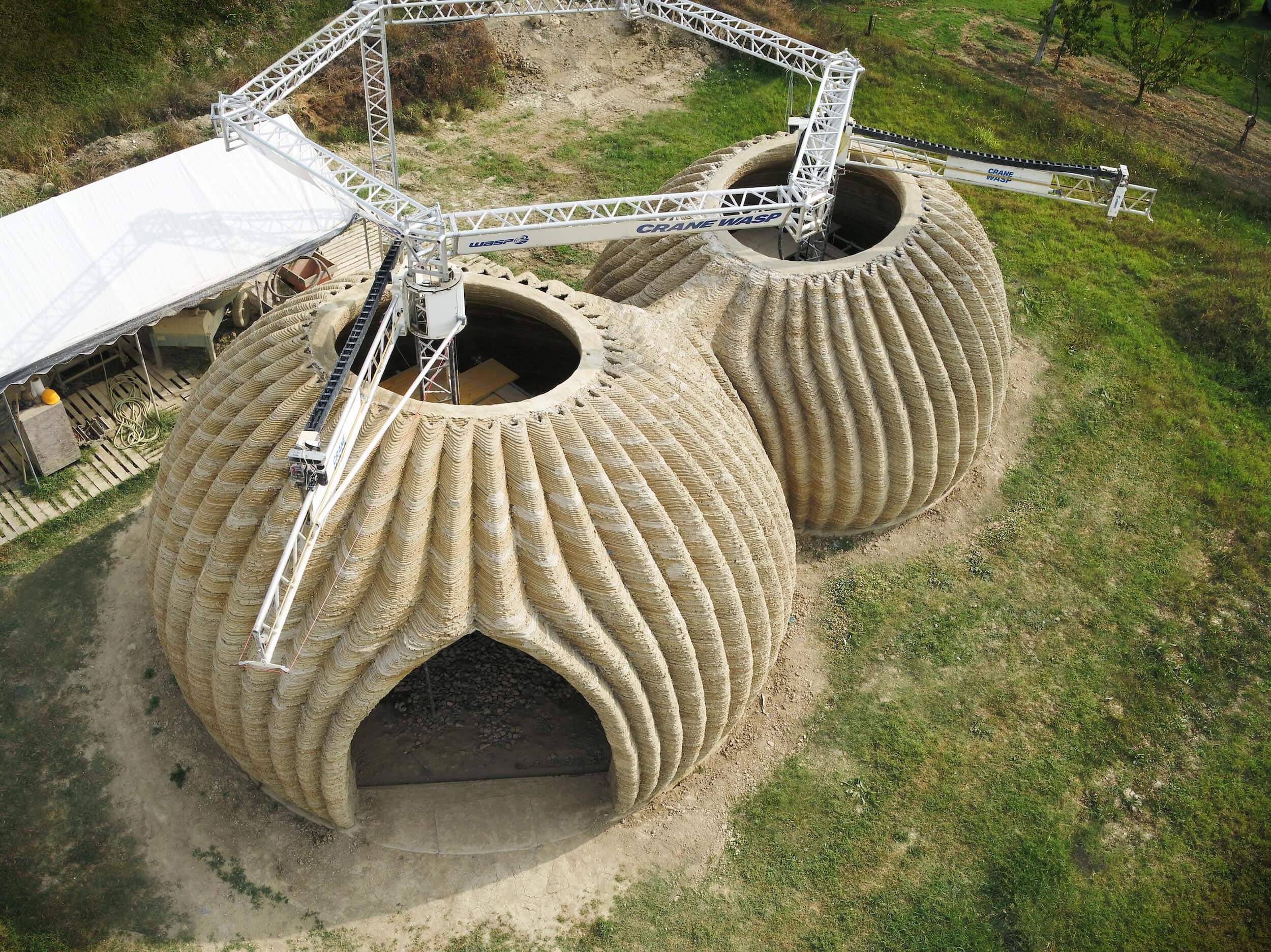 aerial view of 3D printers at work on a earthen home project in italy