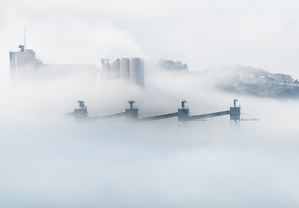 A white smokey cityscape. Skanska is proposing a tool to cut down on embodied carbon emissions.