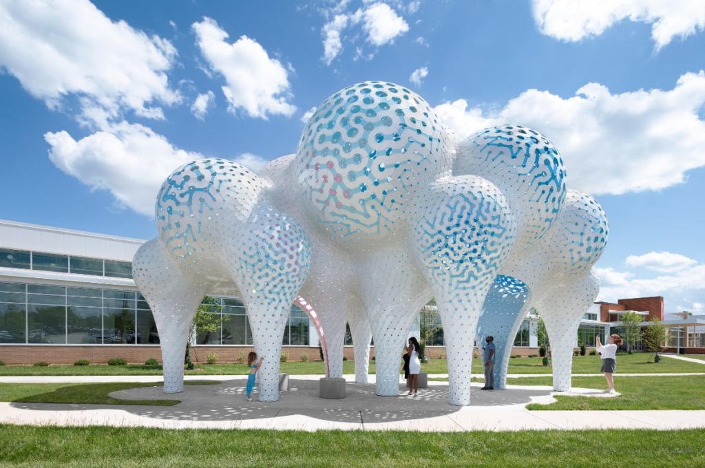 Photo of blue and white pavilion with pillars curving out into spheres