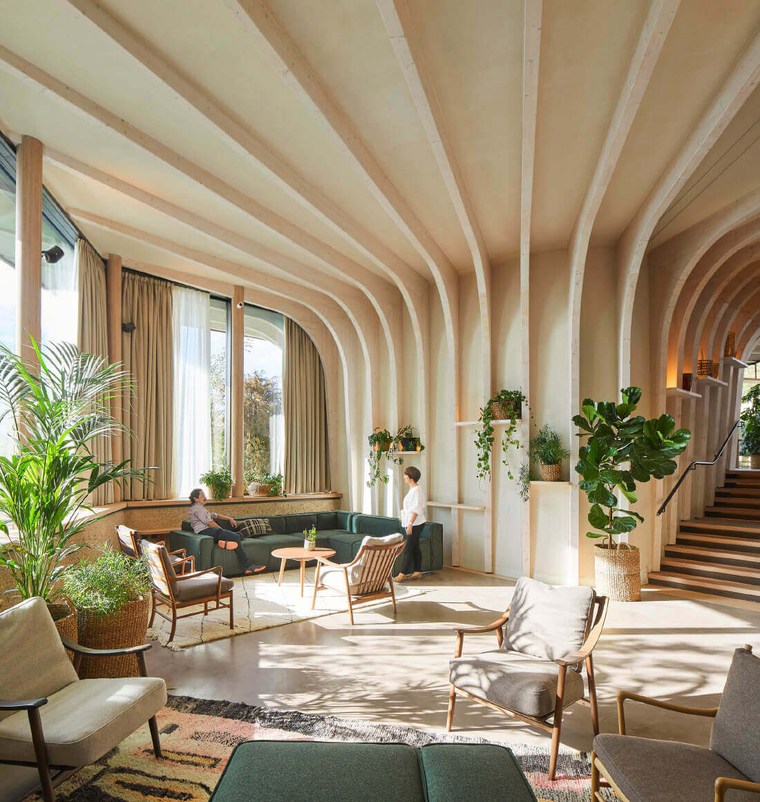 Interior of a timber-framed Maggie's Centre with a roof poking inside